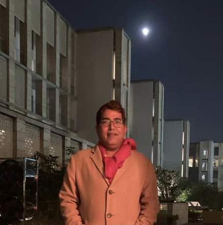 Kewal Kapoor outdoors in Delhi at night, under a full moon