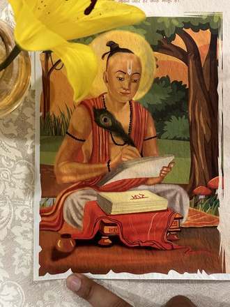 Tulsidas plate photographed beside a lily